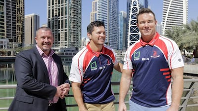 Henry Paul, centre, poses with Dragons chairman Mike Lewis, left, and Paul Hart upon his appointment as head coach of Jebel Ali Dragons in July 2016. Jeffrey E Biteng / The National