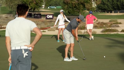 Rory McIlroy of Northern Ireland plays a shot watched by Niall Horan, Paige Spiranac and Saoirse Lambe during the pro-am. David Cannon / Getty Images