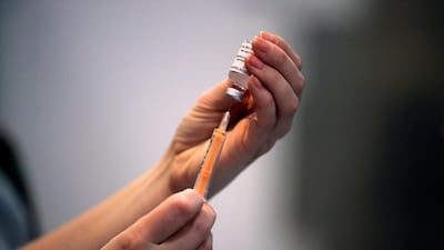 A healthcare worker prepares a dose of the Covid-19 vaccine at Blackburn Cathedral in Lancashire, north-west England. Reuters