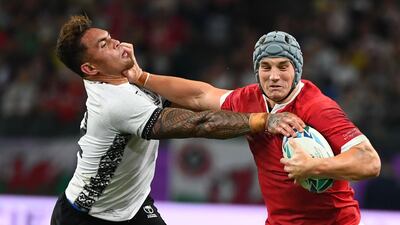 Wales' centre Jonathan Davies (R) runs with the ball past Fiji's centre Jale Vatubua during the Japan 2019 Rugby World Cup Pool D match between Wales and Fiji at the Oita Stadium in Oita. AFP