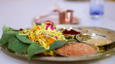 Offerings are set on a puja tray before the prayer ceremony.
