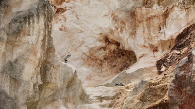 A worker pounds into rock to make gravel and sand in Kenscoff, a neighborhood of Port-au-Prince, Haiti. AP