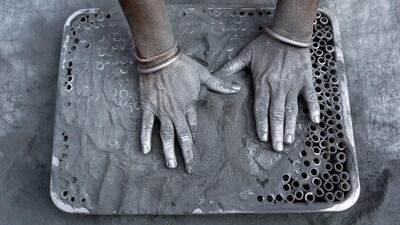 A worker fills small paper rolls with gunpowder mixture to make firecrackers at a factory ahead of Diwali, the Hindu festival of lights, on the outskirts of Ahmedabad, India. Amit Dave / Reuters
