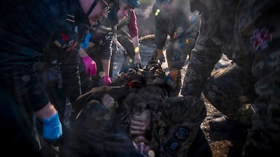 Paramedics transfer a Ukrainian soldier wounded at the Bakhmut front line to a field hospital. EPA
