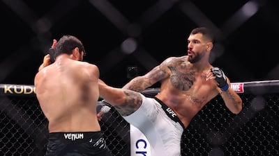 Magomed Ankalaev, left, blocks a kick from Aleksandar Rakic