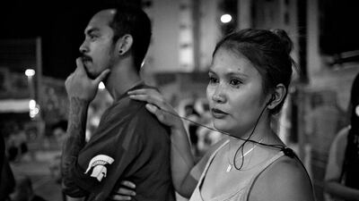 Lyn Veras watches a semi-finals match with her boyfriend Homar Tamares.