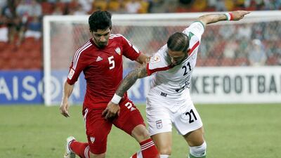 UAE's Amer Abdulrahman fights for the ball with Iran's Ashkan Dejagah during their Asian Cup Group C match at the Brisbane Stadium. Edgar Su / Reuters