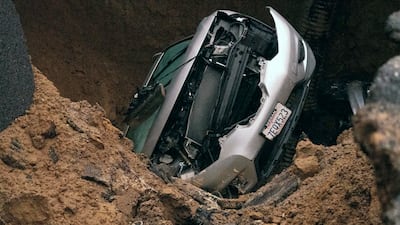 A woman and a young girl are recovering after being trapped inside one of the vehicles at the bottom of a large water-filled sinkhole on Monday night. The Orange County Register / AP