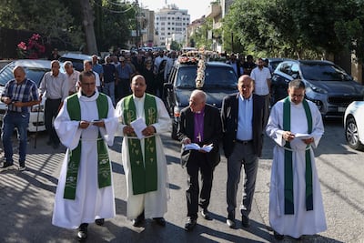 Mourners and members of the clergy march during the funeral procession. AFP