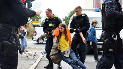 An activist blocking a road is removed by police during a protest in Berlin. Reuters