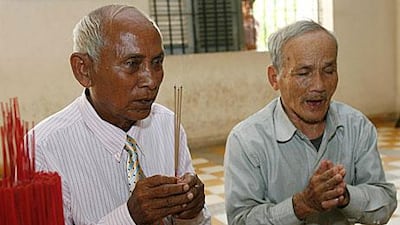 Chum Mey, left, and Bou Meng, two survivors of Cambodia's Khmer Rouge prison S-21 pray ahead of the appeal verdict in the case against Kaing Guek Eav alias 'Duch', the former prison chief.