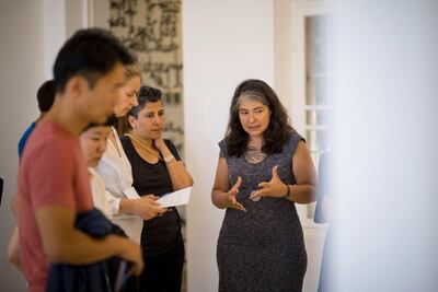 Curator Ovul Durmusoglu (right) leads a tour of the exhibition. Emad Mohammad Zyoud