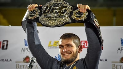 UFC lightweight champion Khabib Nurmagomedov raises his championship belt upon arrival in Makhachkala. AFP