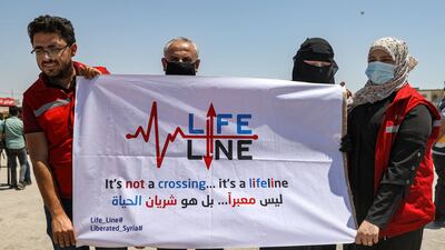 Humanitarian workers gather near the town of Sarmada in rebel-held north-western Idlib province in Syria to demonstrate against the closure of the Bab Al Hawa border crossing. AFP