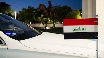 The flag of Iraq on the vehicle escorting Mr Al Sudani at Al Shati Palace
