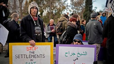 Peace demonstrators raise signs during a protest near the house of a Palestinian family, which an Israeli court had ordered to be evicted while declaring Israeli settlers to be the legal owners, in the East Jerusalem neighbourhood of Sheikh Jarrah. AFP