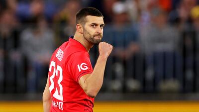 Mark Wood of England celebrates after taking the wicket of Marcus Stoinis. EPA