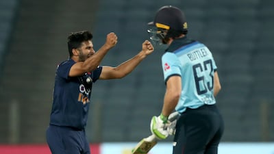 India's Shardul Thakur, left, celebrates the dismissal of England's Jos Buttler at the Maharashtra Cricket Association Stadium in Pune on Tuesday. AP
