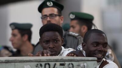 African migrants stand in front of Israeli border police in Tel Aviv. Ariel Schalit / AP Photo