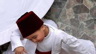 Anas Al Kharrat, 3, dances at his home. AFP