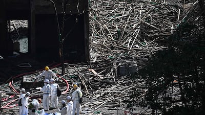 Police look for bodies at one of the buildings. AFP