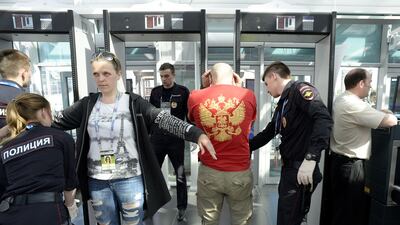 Fans are checked at a security station.