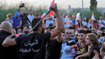 Lebanese demonstrators clash with anti-riot police on the road leading to the Presidential Palace in Baabda, on the eastern outskirts of Beirut on November 13, 2019, nearly a month into an unprecedented anti-graft street movement. Street protests erupted, the night before, after President Michel Aoun defended the role of his allies, the Shiite movement Hezbollah, in Lebanon's government. Protesters responded by cutting off several major roads in and around Beirut, the northern city of Tripoli and the eastern region of Bekaa. / AFP / ANWAR AMRO