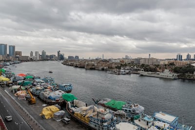 Old Dubai's boats under overcast skies with their cargo covered in plastic sheets to protect it from the rain. Antonie Robertson / The National
