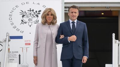 French President Emmanuel Macron and his wife Brigitte Macron arrive at the military section of BER Airport, in France, ahead of their three-day state visit to Germany, Sunday, May 26, 2024. (Christophe Gateau / dpa via AP)