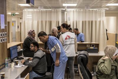 Staff members and NGO workers in the reception of the emergency room of the Governmental Hospital in Jenin, in the occupied West Bank. AFP