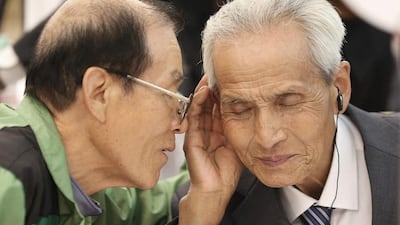 South Korean Song Byong-chan, 76, left, whispers to his North Korean brother Song Byong Sang, 82, during the reunion at the Diamond Mountain resort in North Korea. Yonhap via AP
