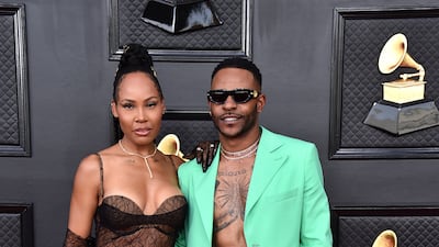 La'Myia Good and Eric Bellinger, shirtless in a turquoise suit. AP