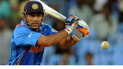 MS Dhoni, the Indian captain, hammers his way to an undefeated 108 against New Zealand. Punit Parankpe / AFP