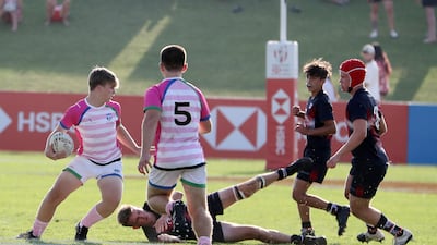 Players in action during the Gulf Under 19 boys cup semi-final 1 match between Dubai College (black) vs S22 UAE Academy (white and pink).