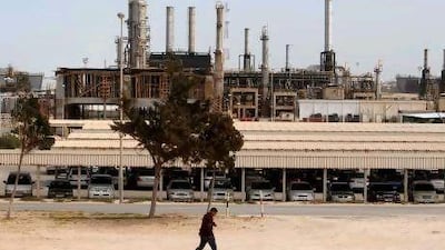 A man walks past the Azzawiya oil refinery in Zawiyah, 50km west of Tripoli. Reuters