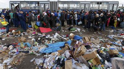 Migrants wait to board a bus at a migrant collection point in Roszke, Hungary. Laszlo Balogh / Reuters