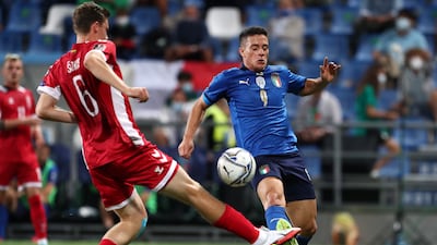 Giacomo Raspadori of Italy is challenged by Benas Satkus of Lithuania. Getty Images