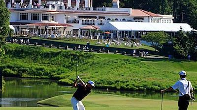 A golfer goes through his practice round on the 18th hole.