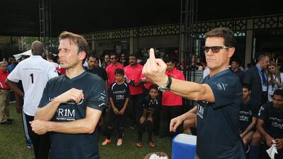 Fabio Capello, coach of Team Laureus, gives instructions as Gaizka Mendieta of Team Laureus looks on during the Laureus All Stars Unity Cup. Ian Walton / Getty Images / March 25, 2014