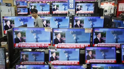 A sales assistant in Seoul, South Korea watches TV sets broadcasting a news report on North Korea’s hydrogen bomb test. Kim Hong-ji / Reuters