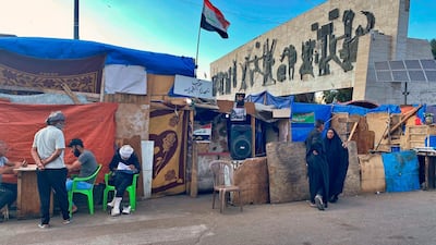 Anti-government protesters stand in Tahrir Square, Baghdad during anti-government protests. AP Photo