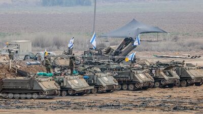 Israeli soldiers and military vehicles near the border with Gaza. EPA
