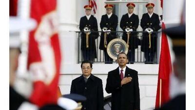 The US president, Barack Obama, and the Chinese president, Hu Jintao, take part in an official arrival ceremony for Mr Hu on the South Lawn of the White House in Washington yesterday.