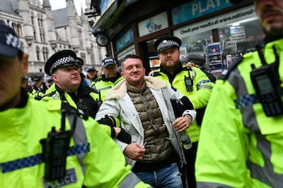 Metropolitan Police officers arrest British far-right activist Tommy Robinson during a demonstration in central London to protest against antisemitism. AFP