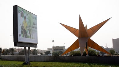 An advertisement for Saudi Aramco's initial public offering (IPO) stands on a roadside in Dammam, Saudi Arabia. Bloomberg