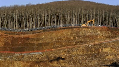 An excavator moves next to a tree line at the construction site of a mine of Hellas Gold, a subsidiary of Canadian mining company Eldorado Gold Corp, in Skouries, in the Halkidiki region, northern Greece. Greece's new government will take steps to halt a Canadian-run gold mine project and aims to cancel a development scheme at Athens' former airport, pressing ahead with plans to roll back the country's privatisation programme. The government is dominated by the left-wing Syriza party, which has for years opposed the Skouries gold mine in northern Greece, operated by Vancouver-based Eldorado Gold Corp. Alexandros Avramidis / Reuters