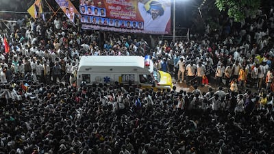 An ambulance carrying the dead and injured makes its way through the crowd after a crush at a political rally in the Karur district of Tamil Nadu, India. Dozens were killed. AFP