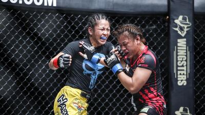 The One Fighting Championship "Reign Of Champions" mixed martial arts tournament held at the Dubai World Trade Center. Ben Askren celebrates after beating Nobutatsu Suzuki in the first round of the Welterweight World Championship. Ana Julaton (Philippines, yellow shorts) vs Ann Osman (Malaysia, black shorts). Antonie Robertson / The National