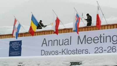 Workers shovel snow from the roof of the congress centre. Arnd Wiegmann / Reuters