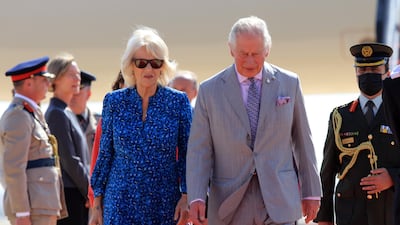 Prince Charles and Camilla, Duchess of Cornwall, wearing a blue flowery dress by Fiona Clare, arrive at Queen Alia International Airport in Amman, Jordan. EPA